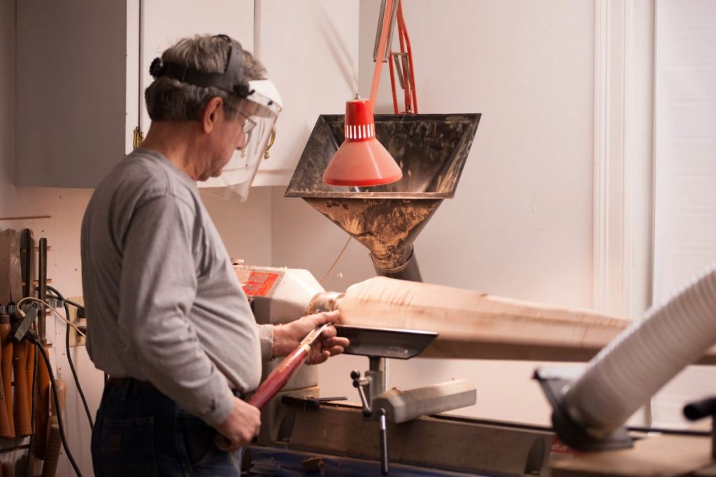 Man turning wood on a lathe