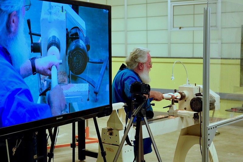 Man presenting his woodturning on a convention